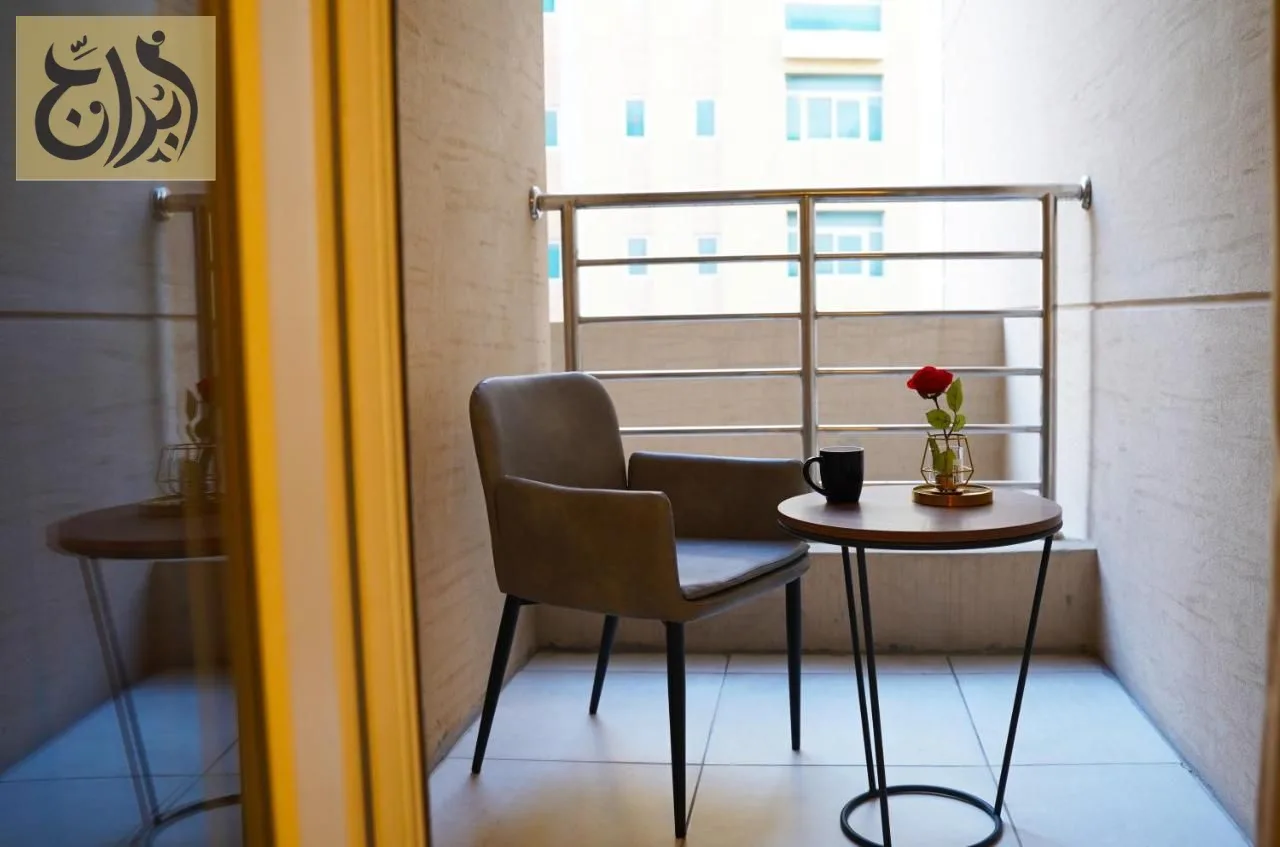 Balcony seating with table and chair in a suite at Abraj Suites Hotel, Al Mansoura, Doha