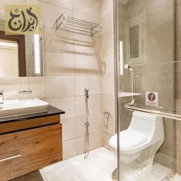 Private bathroom with shower in a furnished apartment at Abraj Suites Hotel Doha