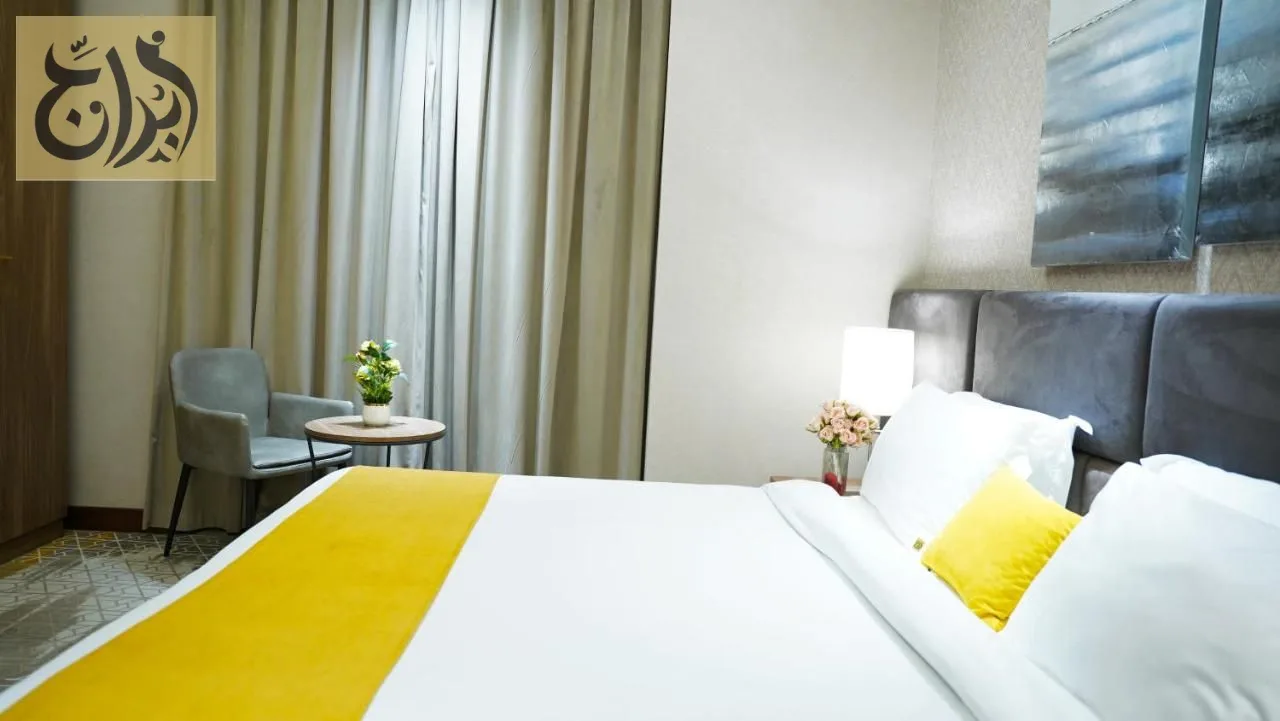 Bright suite bedroom with king bed at Abraj Suites Hotel Doha