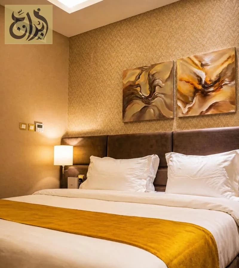 Suite bedroom with twin bed configuration at Abraj Suites Hotel Doha