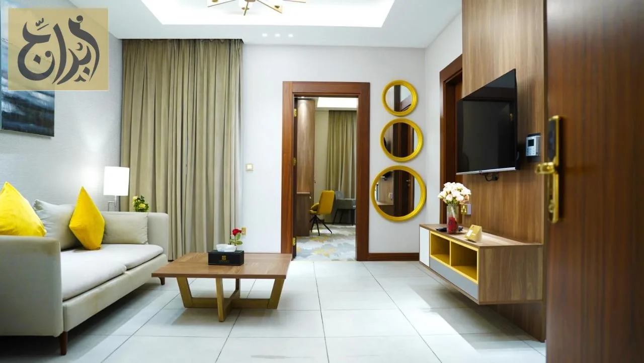 Living room with entertainment unit in a one-bedroom suite at Abraj Suites Hotel Doha