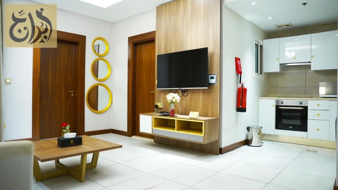 Living room with open kitchen in a serviced apartment at Abraj Suites Hotel Doha