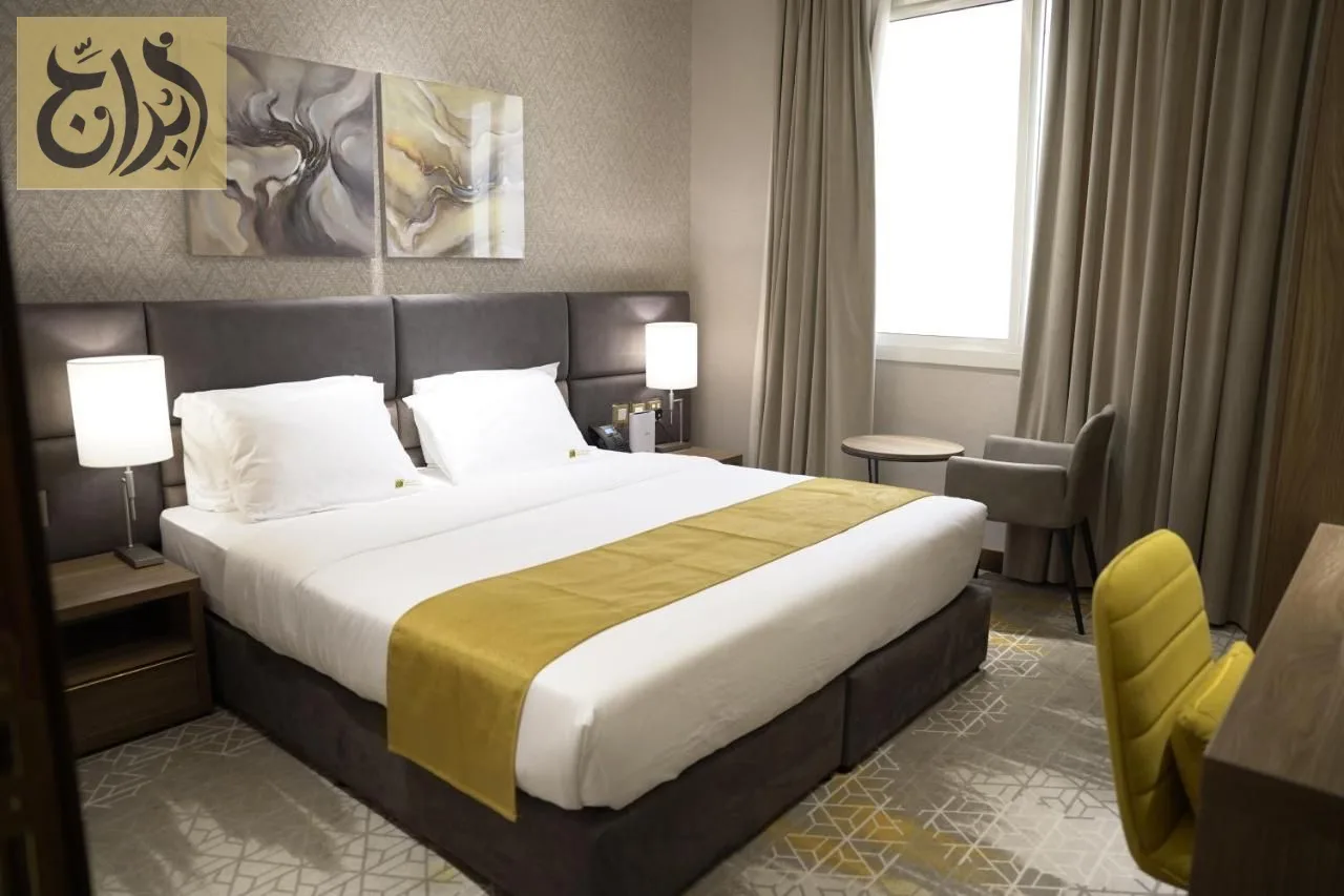 Master bedroom with king size bed in a one-bedroom suite at Abraj Suites Hotel Doha