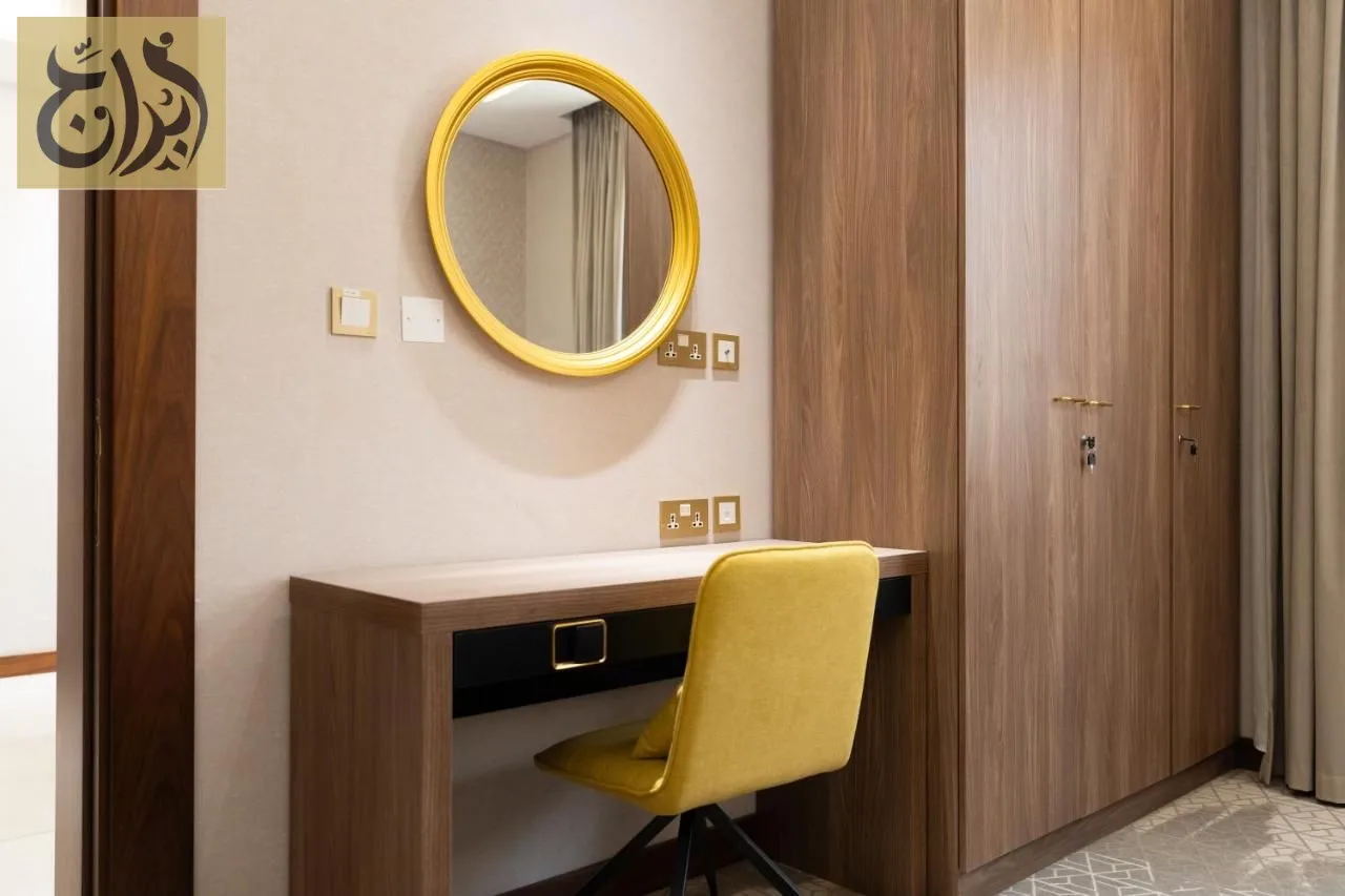 Work desk and mirror inside a one-bedroom suite at Abraj Suites Hotel Doha